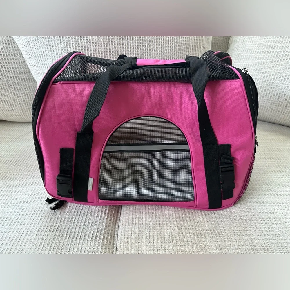 Pink small dog carrying cage.